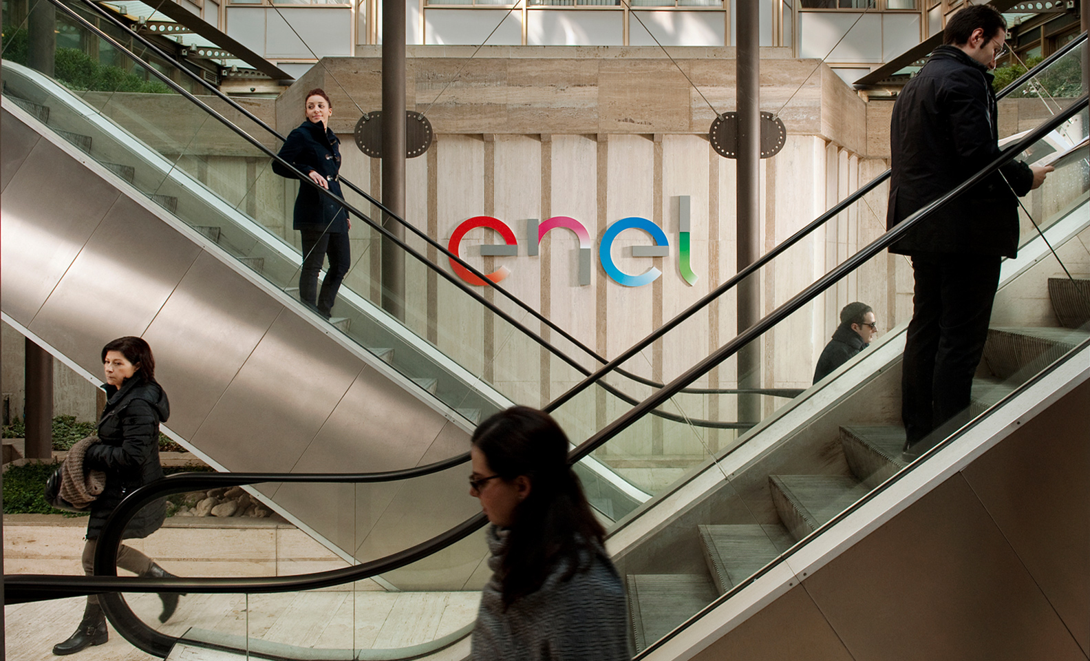 People on the escalators inside Enel headquarters